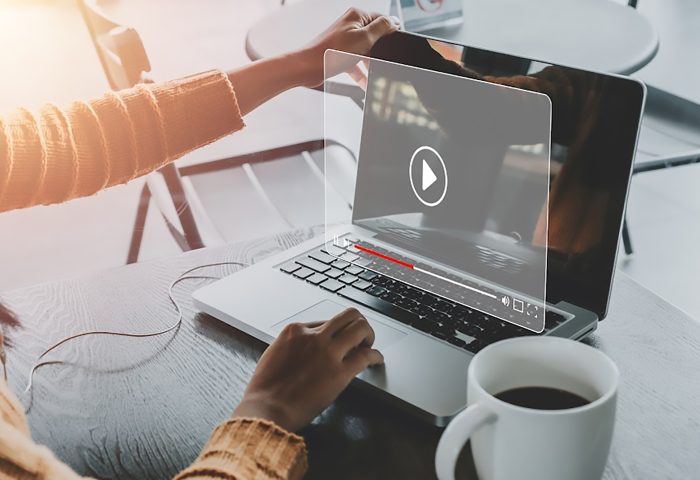 Video streaming on internet, Woman watching online movie or TV series on laptop computer, Concept about subscription based live digital stream.